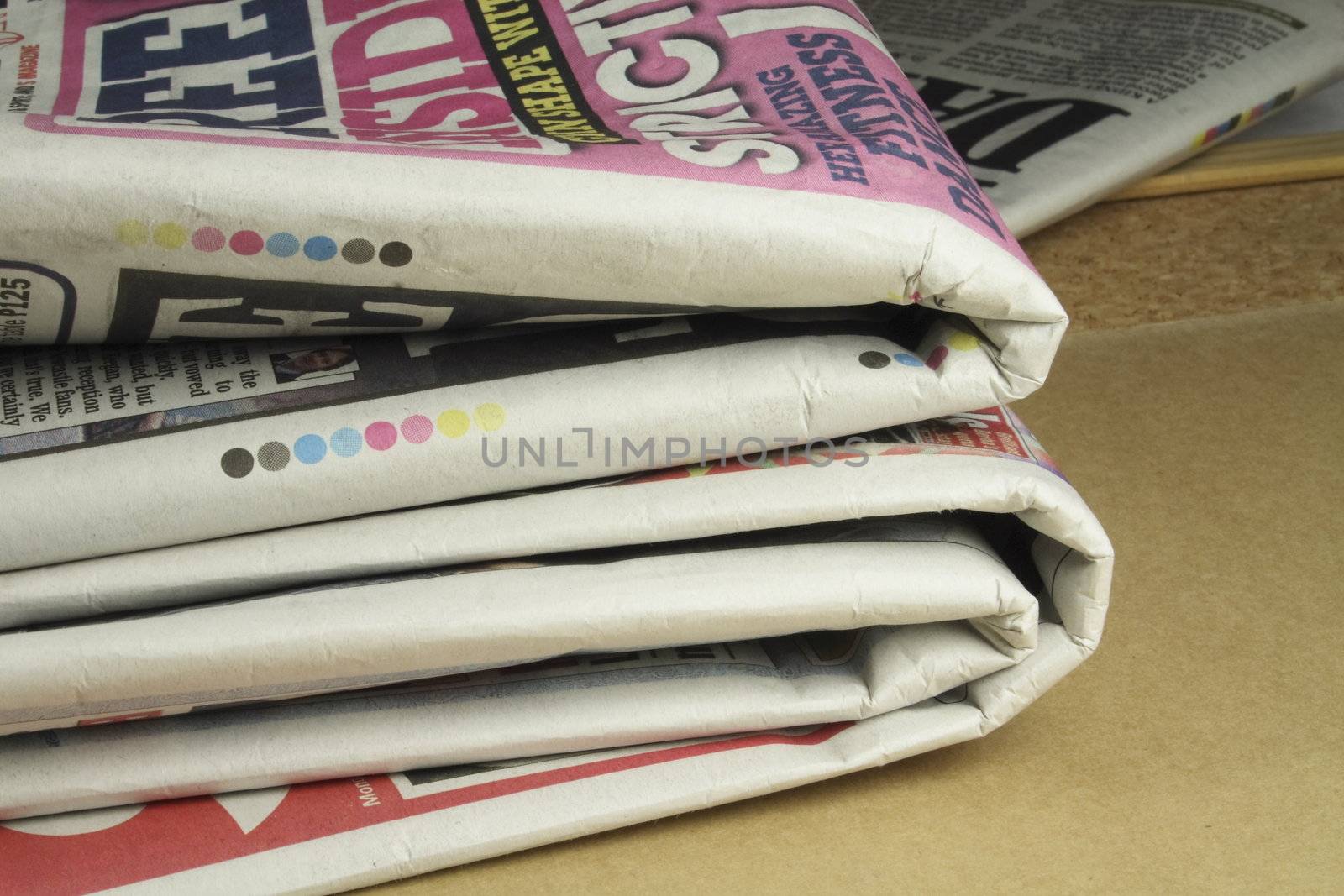 pile of folded and read daily newspapers