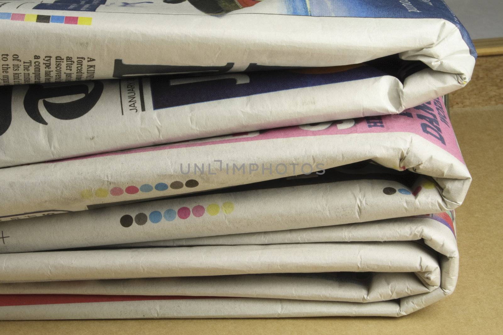 pile of folded and read daily newspapers