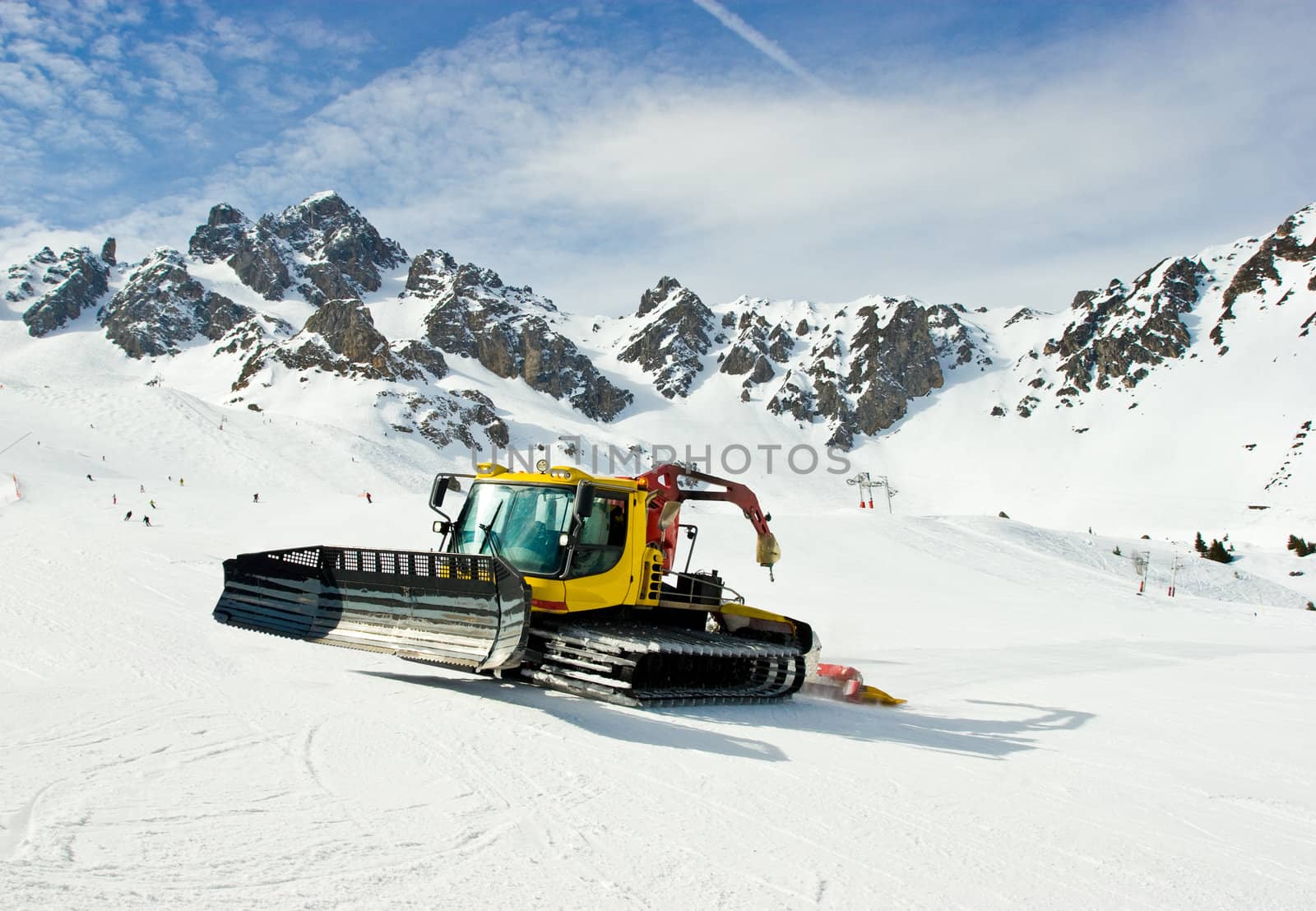 A snowcat grooming the ski slopes at French Alps