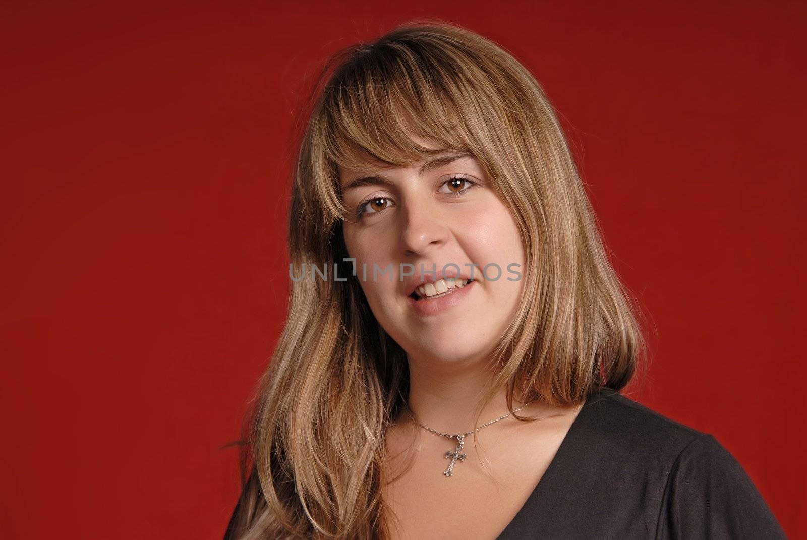 young casual woman portrait on red background