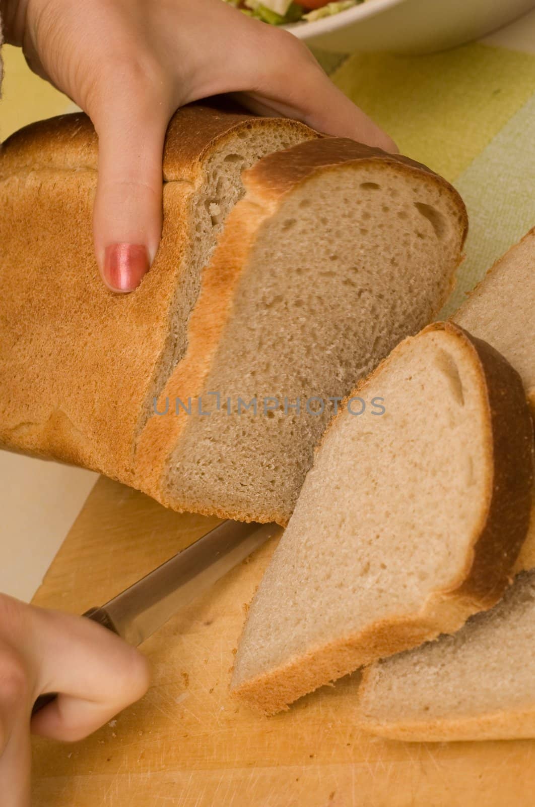 woman cuts bread thin pieces by mafffutochka