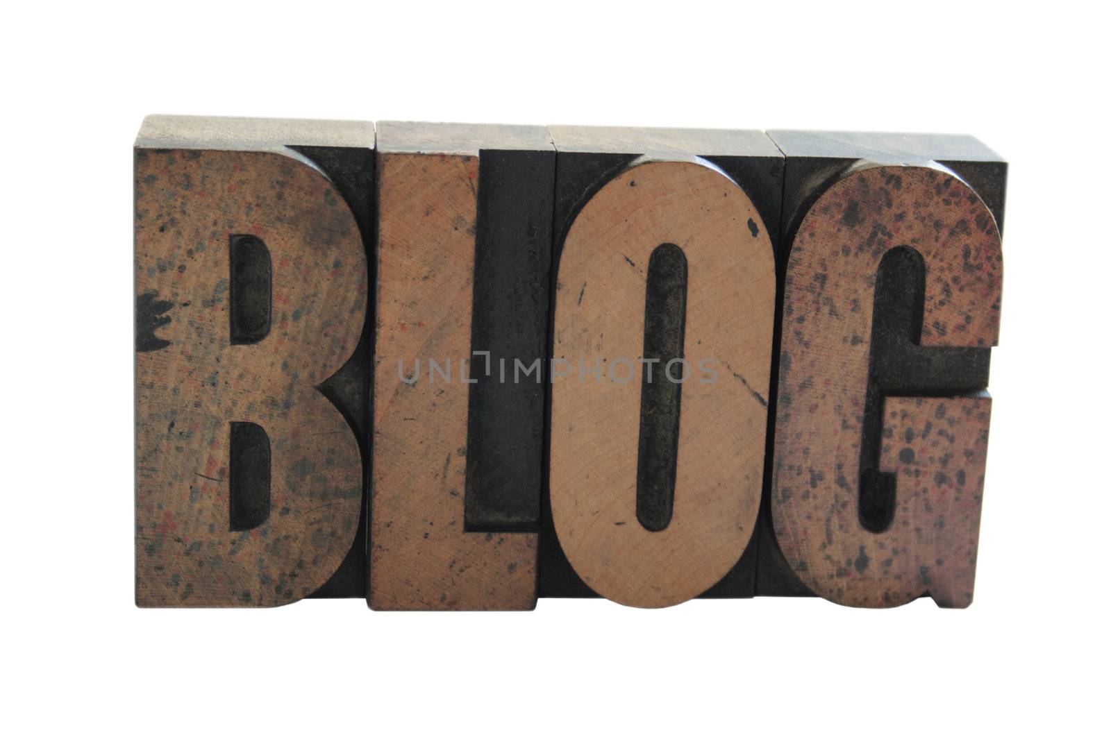 old, inkstained wood letterpress type spells out the word 'blog' in all caps