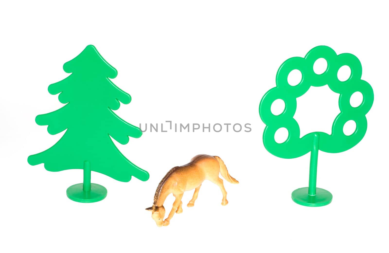 Toy horse among green trees by mafffutochka