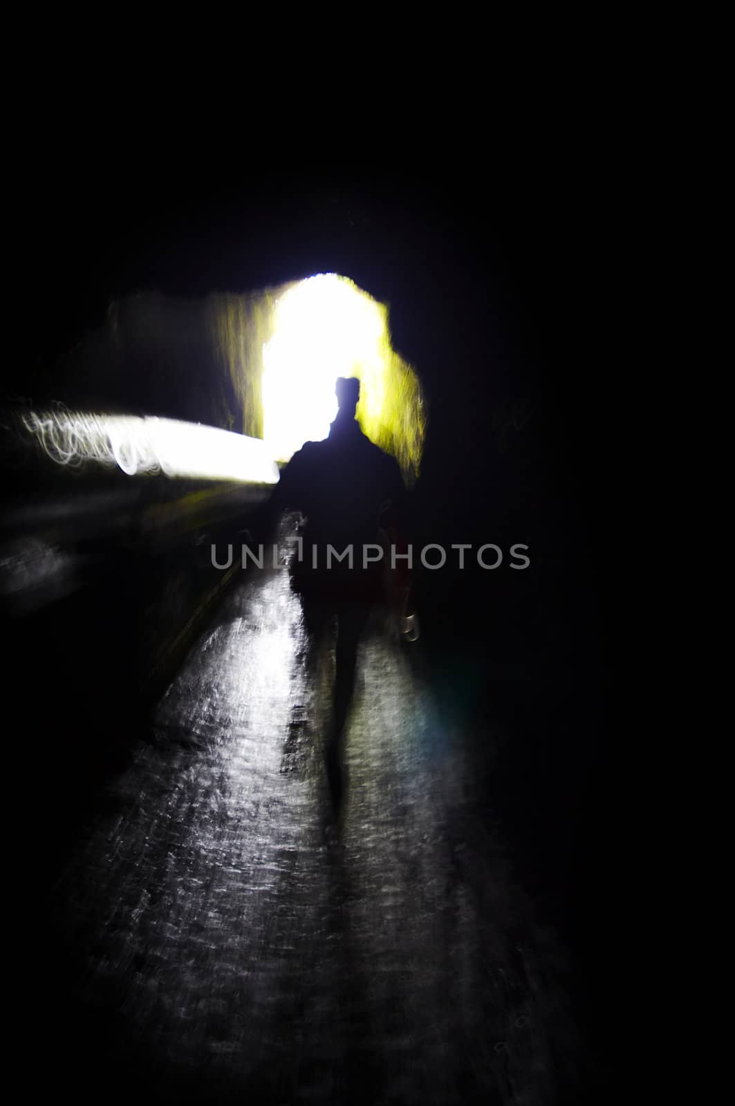 Person walking into the light