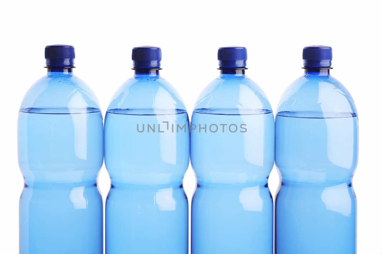 Four blue plastic water bottles lined up