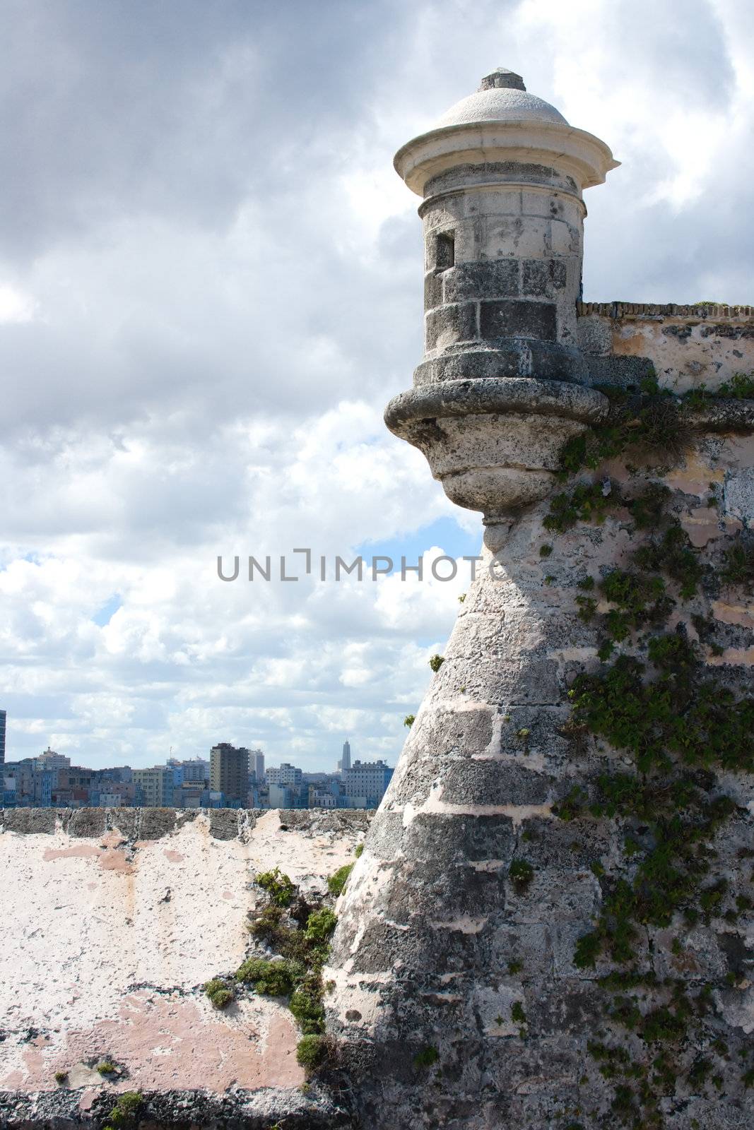 Gun turret and a view of city coastline. El Morro, Havana, Cuba.