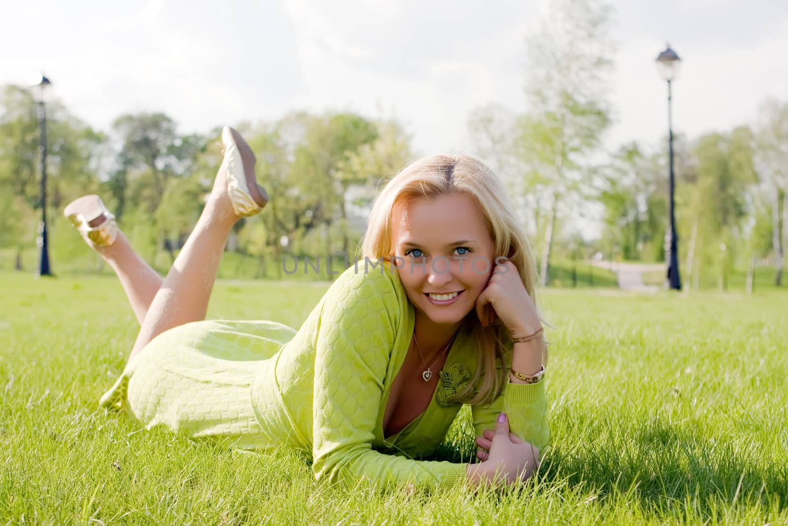 The girl lays on a grass a meadow