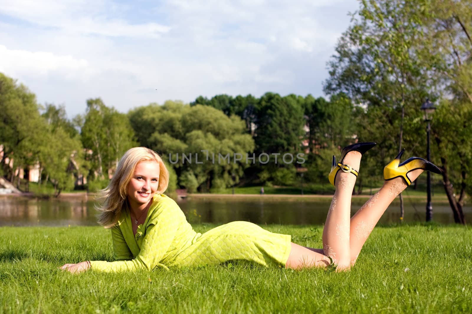 The girl lays on a grass by MIL