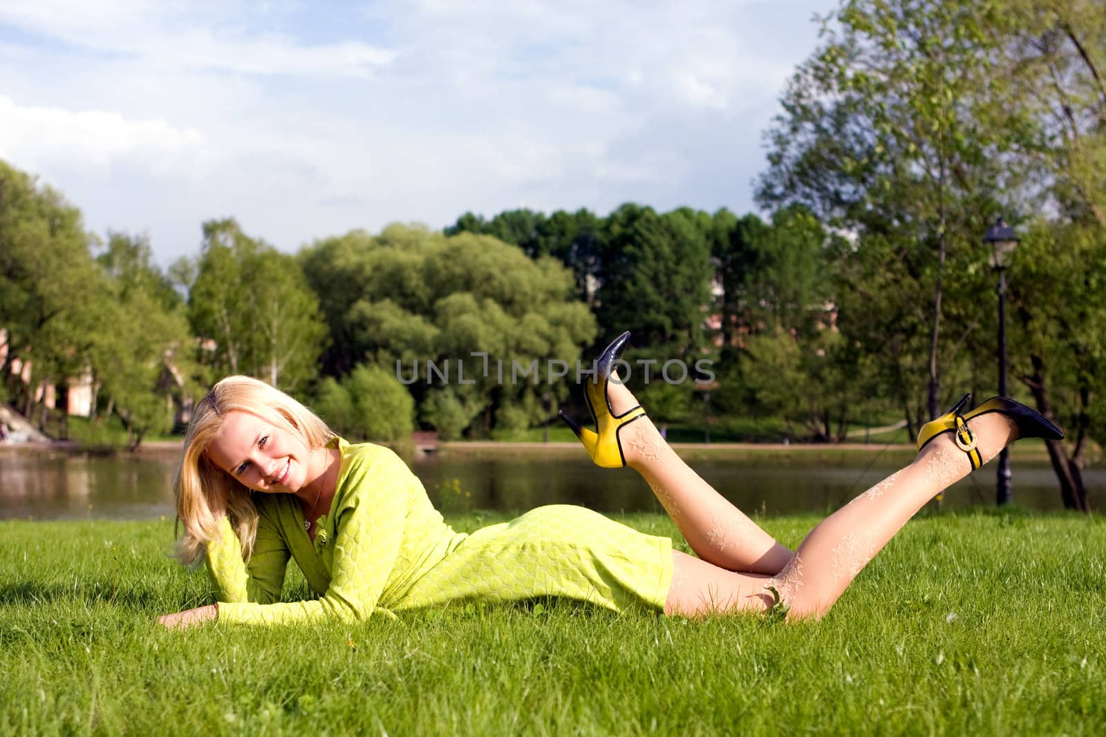 The girl lays on a grass a meadow