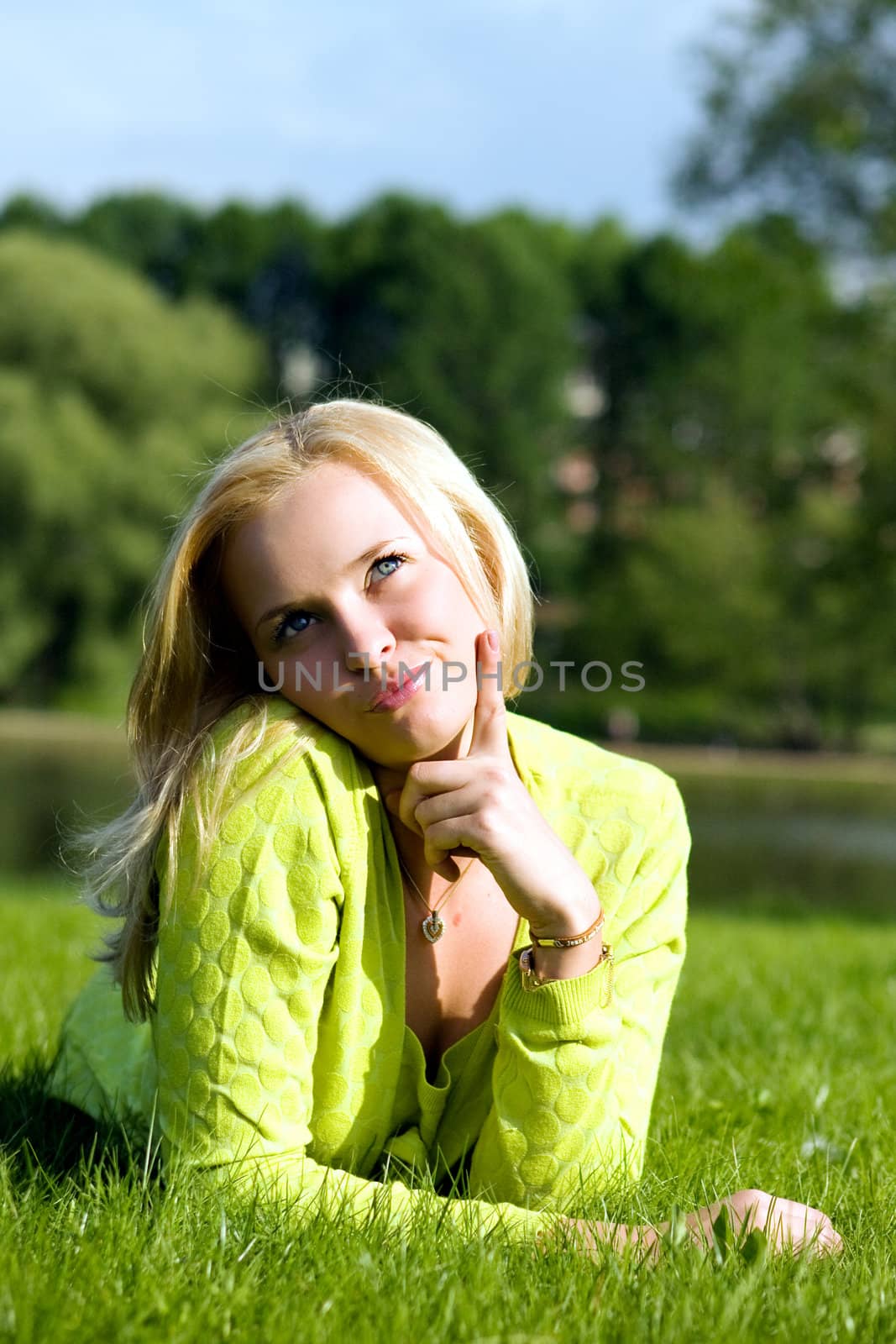 The girl lays on a grass a meadow