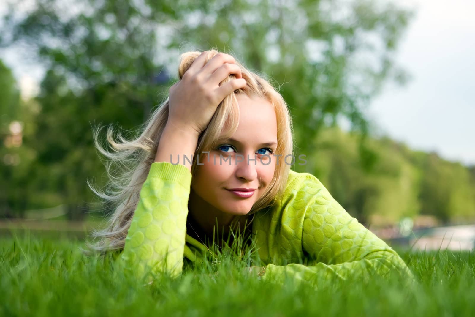 The girl lays on a grass a meadow