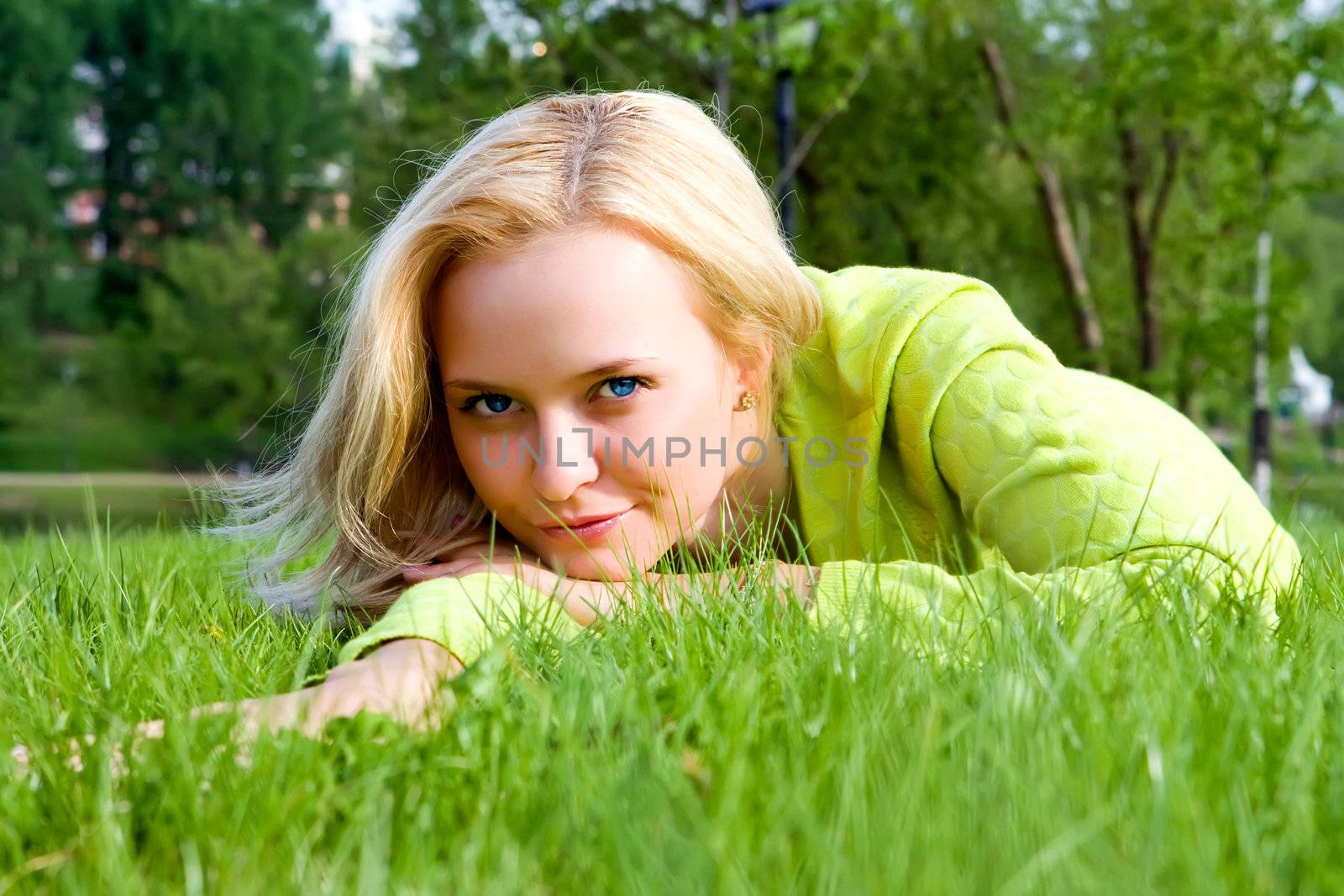 The girl lays on a grass a meadow