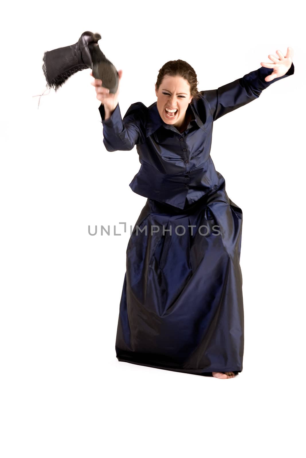 Portrait of a woman with long curly hair throwing her boot in anger.