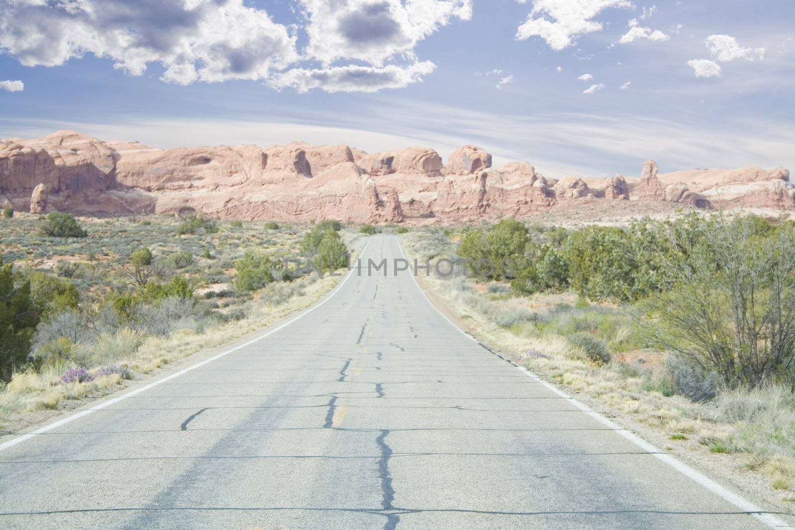 road through arches area mountains and spires in Utah USA