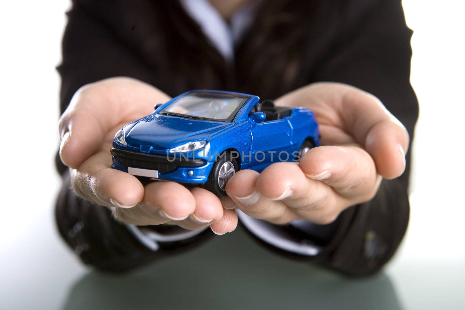 businesswoman holding car in the hands - insurance or car business concept