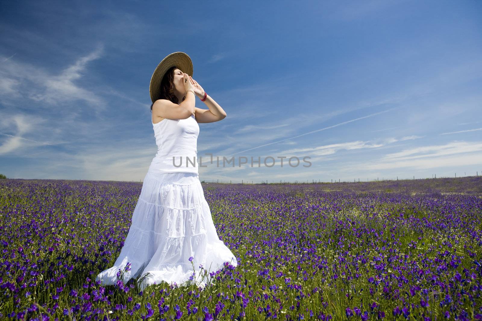 young woman with white dress screaming or singing outdoors