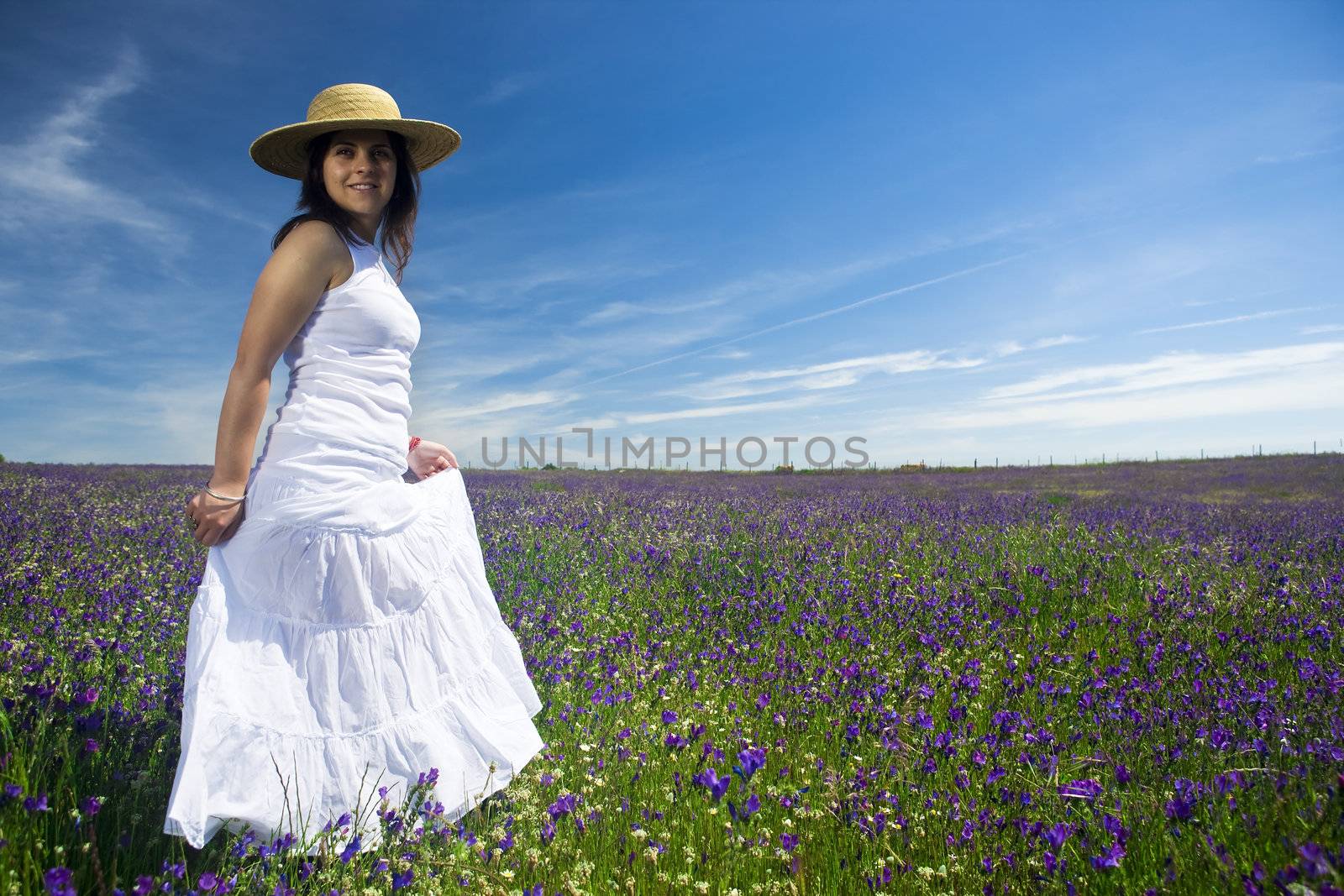 beautiful young woman with white dress in colorful landscape by mlopes