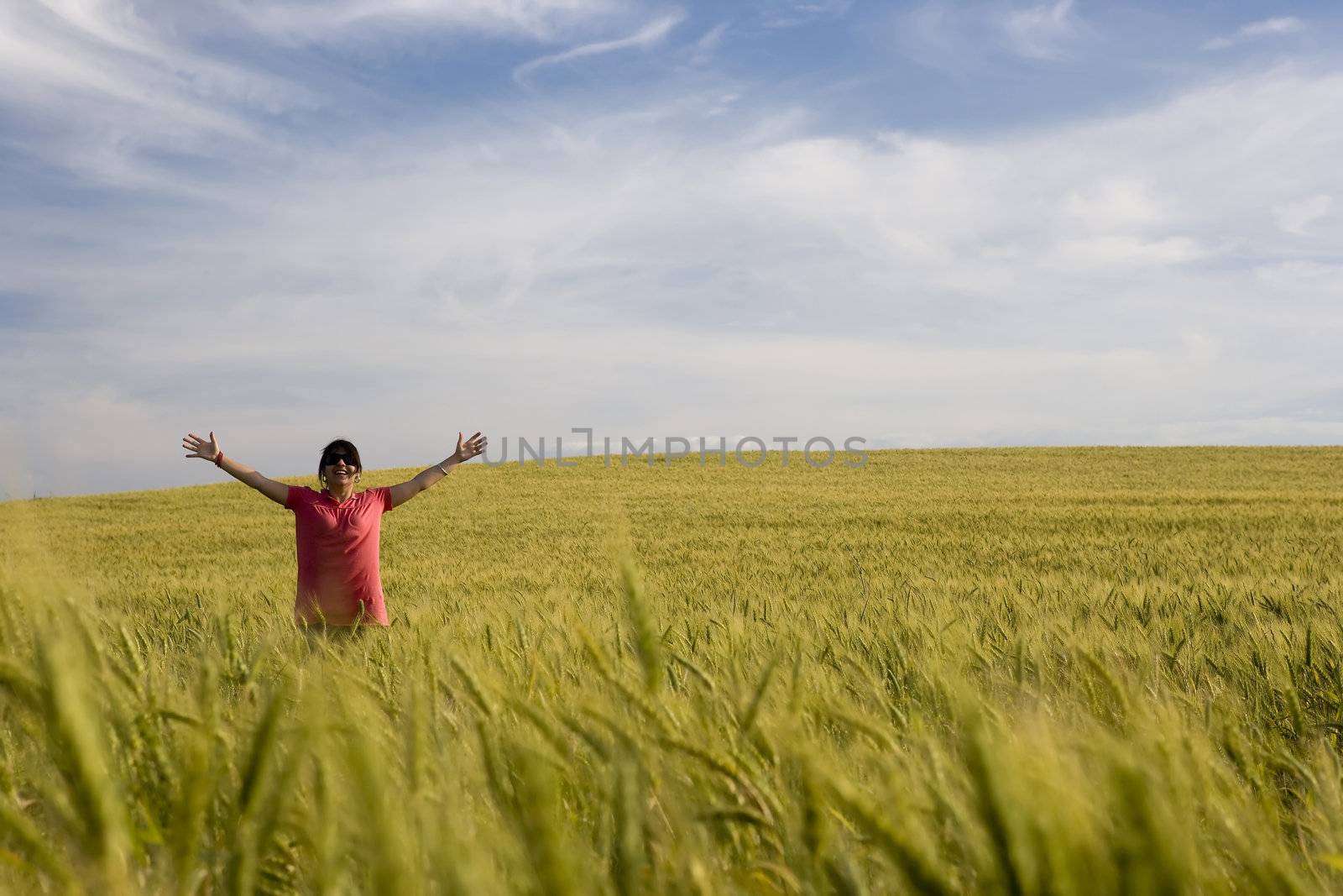 young happy woman in the middle of the field