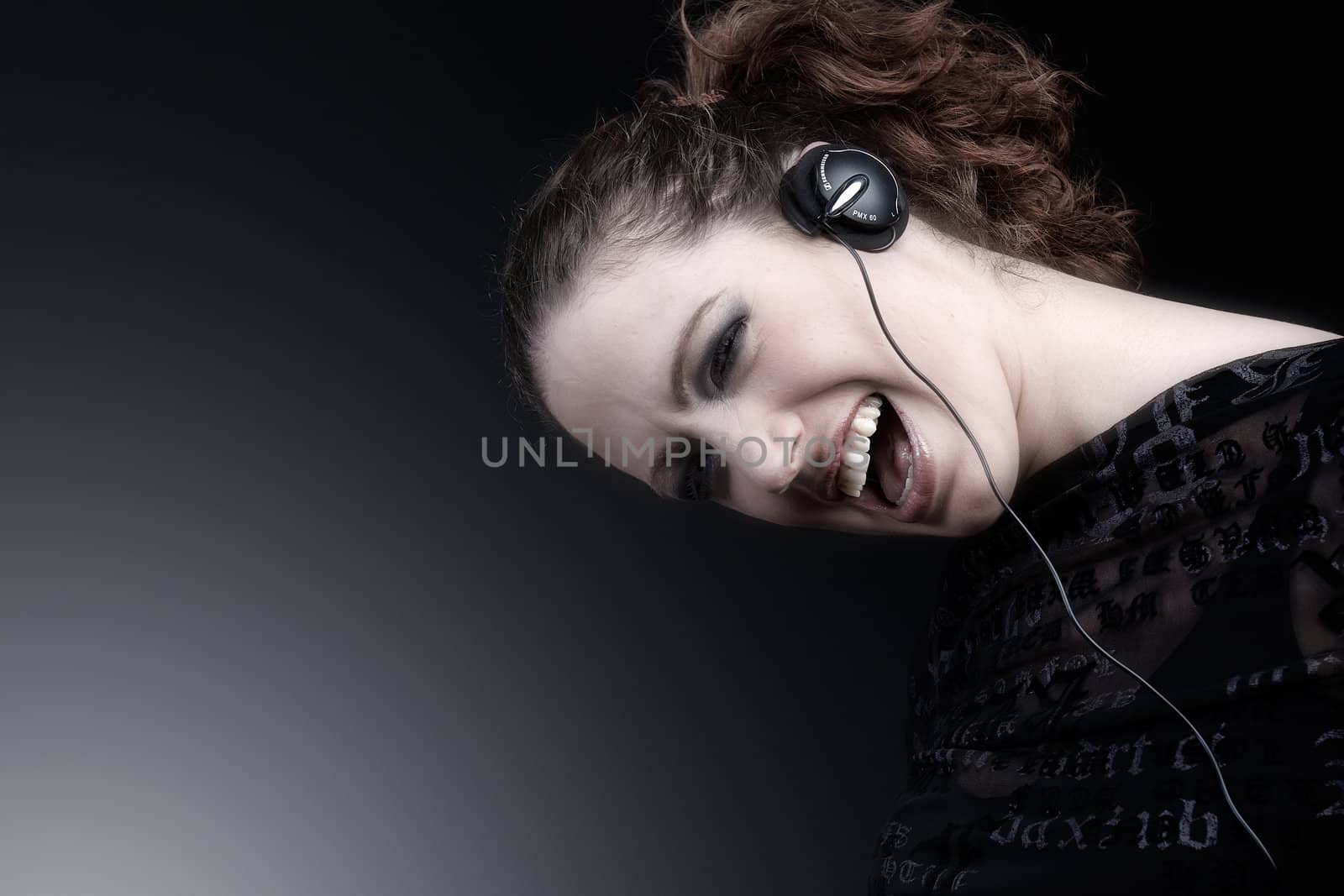 Portrait of a woman with long curly hair and headphones