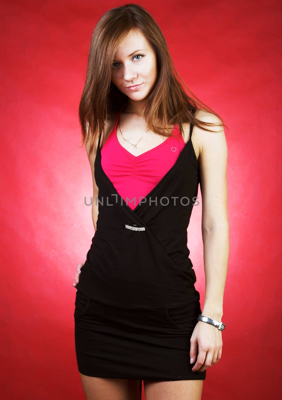 Portrait of a beautiful, sexy girl on red background 