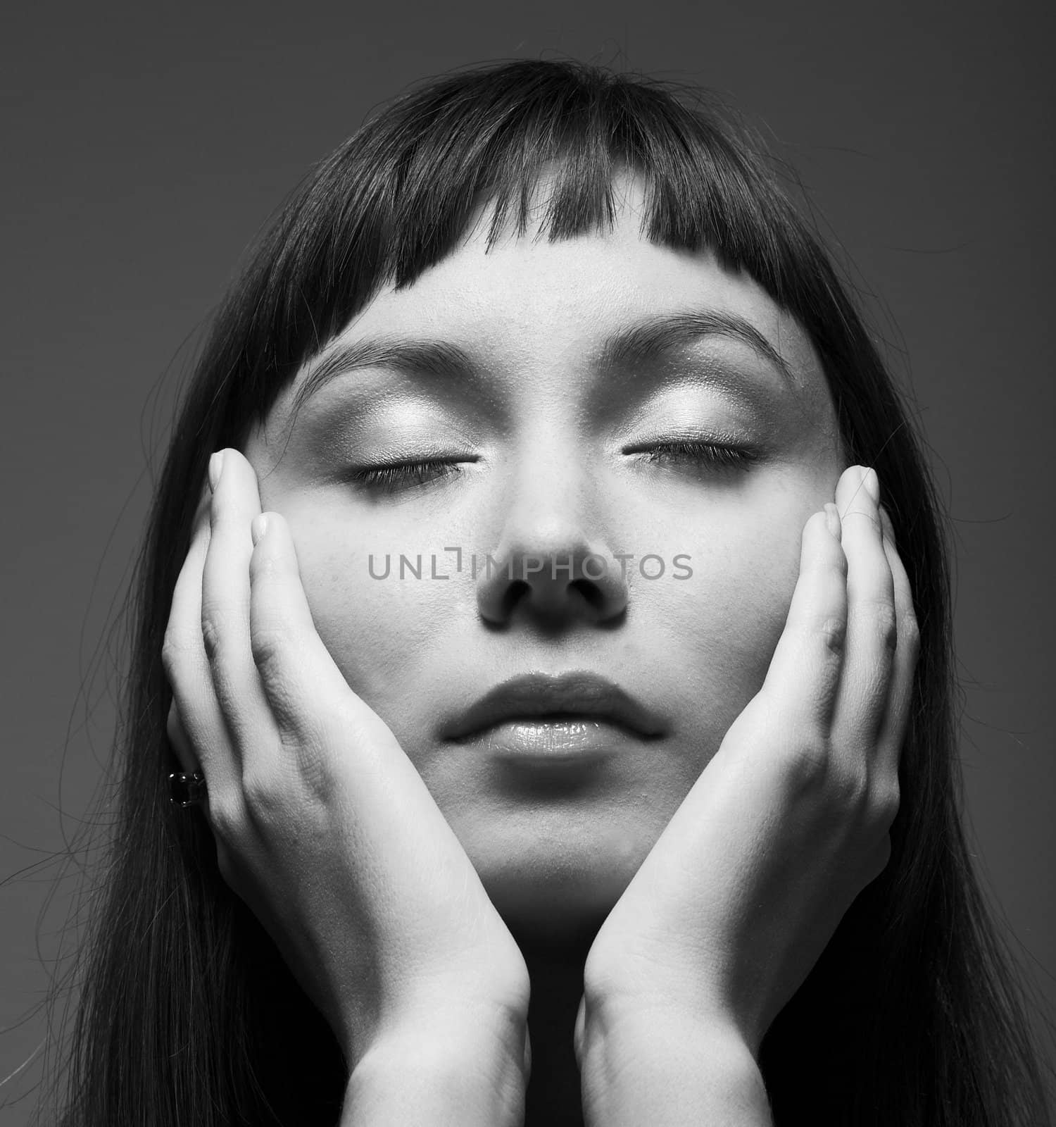 sensual dark portrait of a young woman with closed eyes

