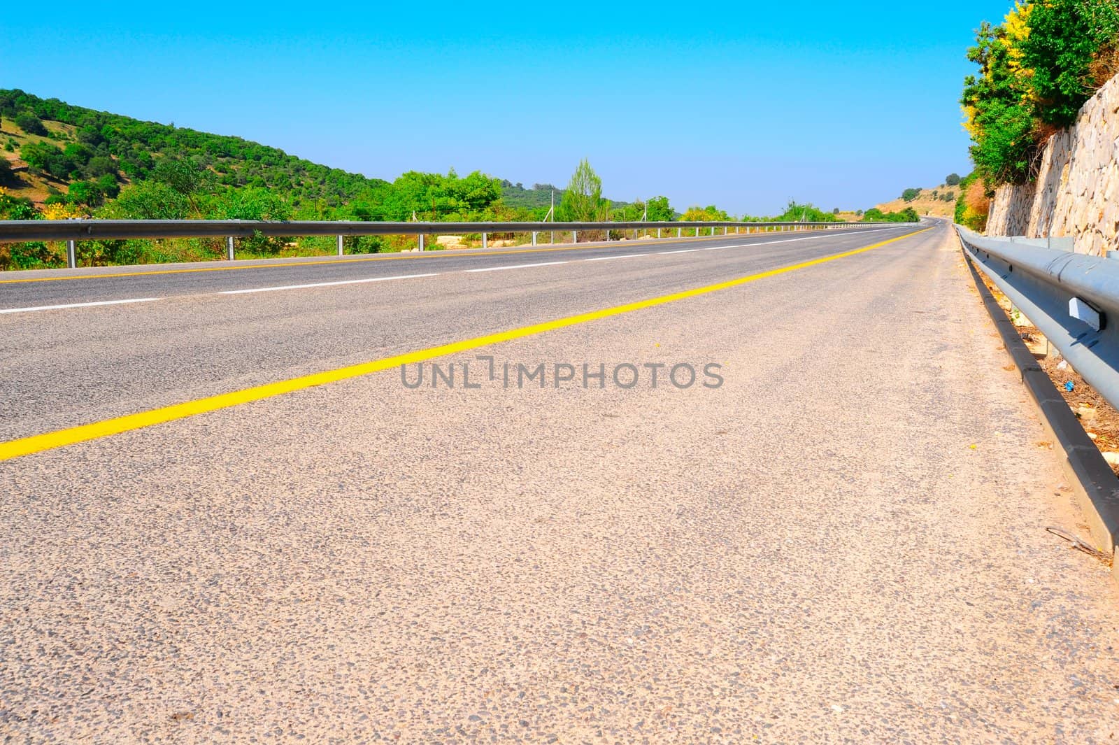 Empty Highway In North Galilee, Israel, Against Blue Sky.