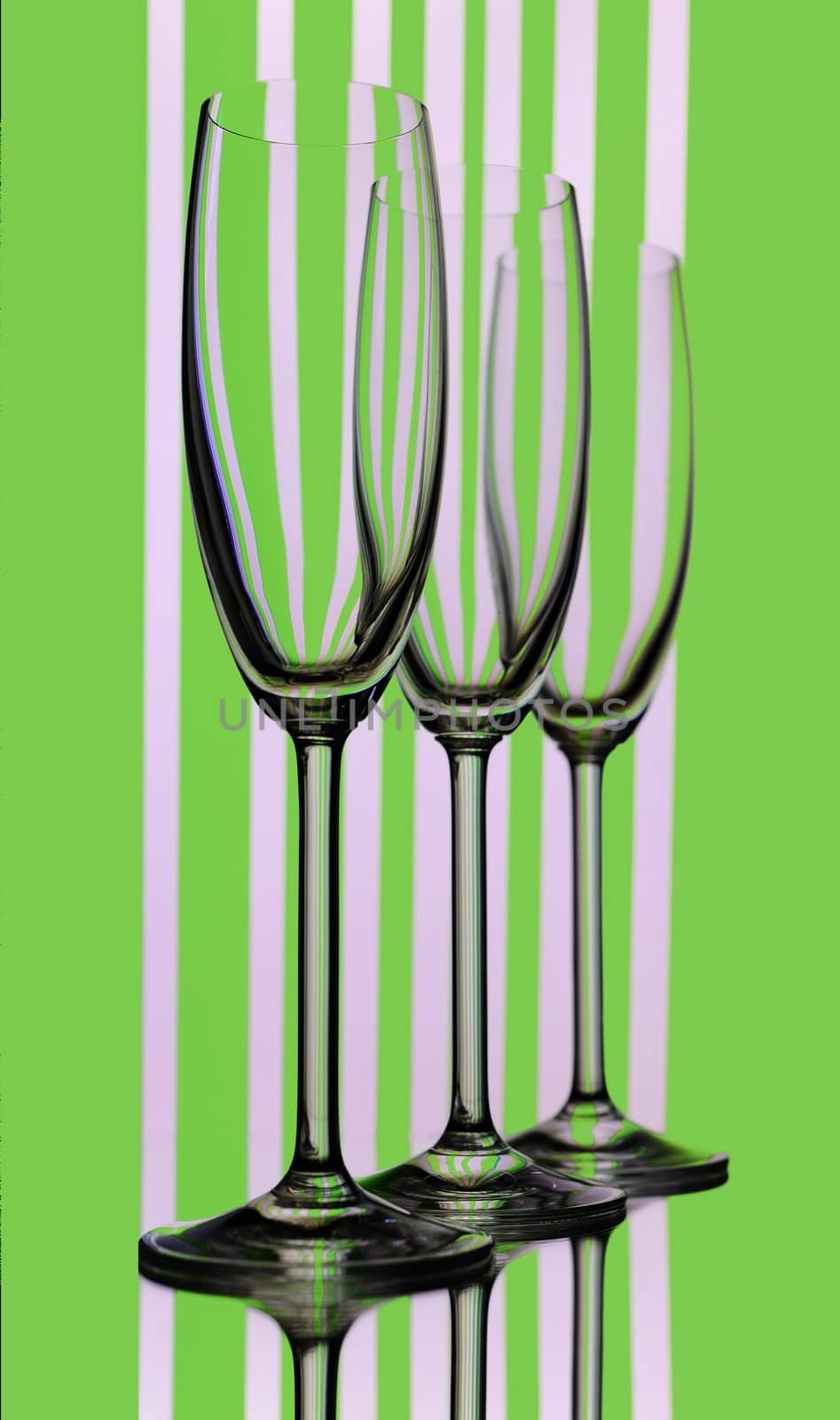 Three Elegant Tall Wineglass For Champagne  Over Striped  Background.