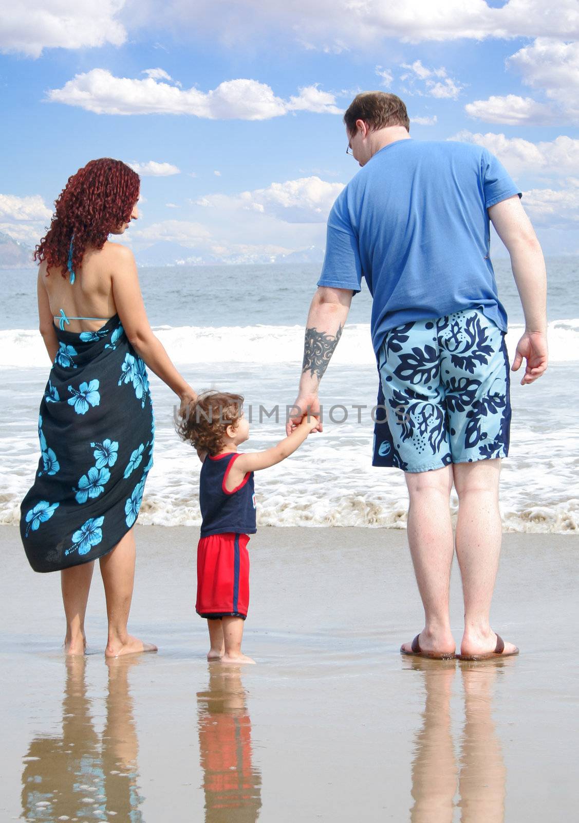 Young happy family together on the beach