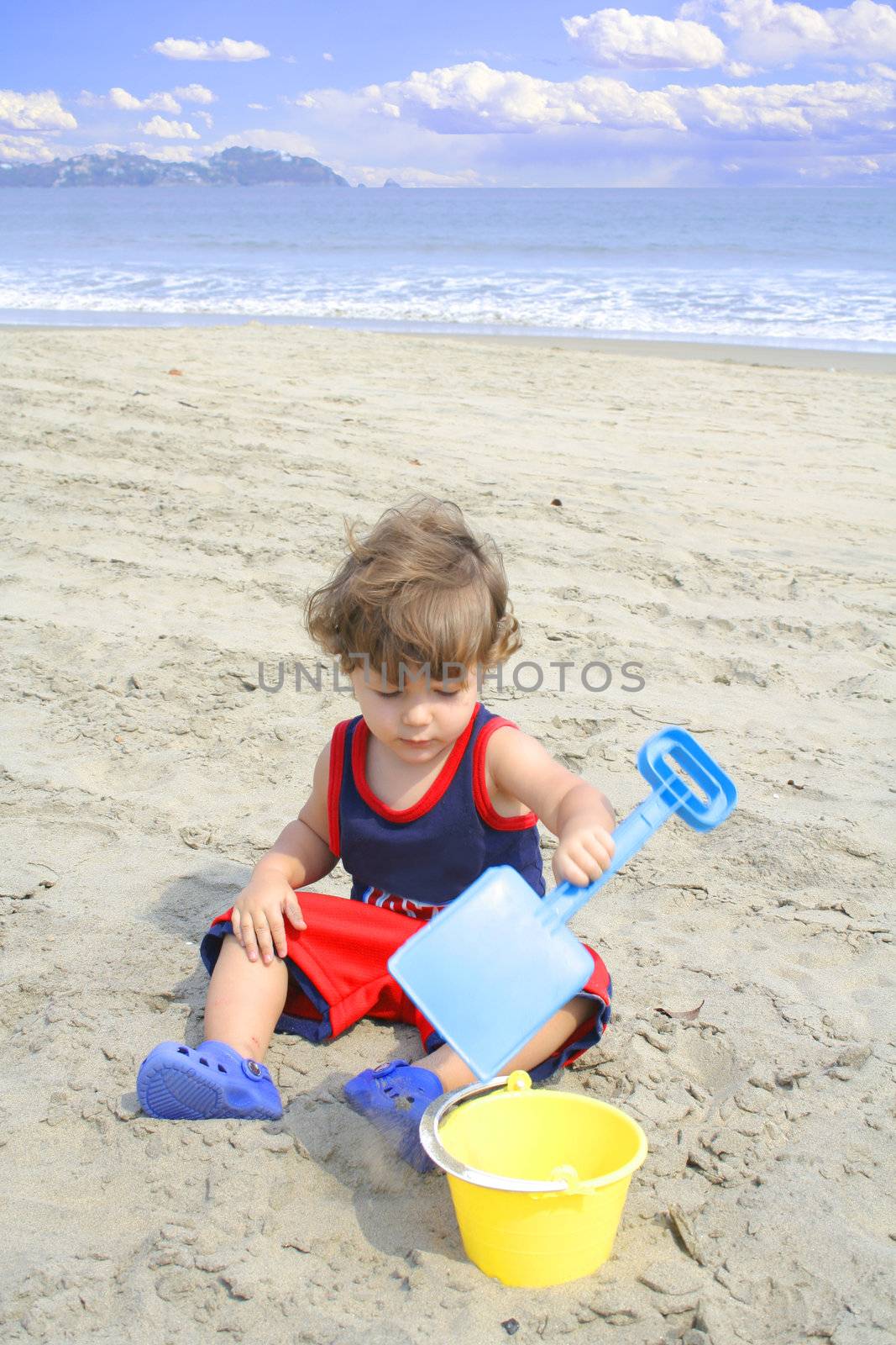 Young child playing in the sand on the beach