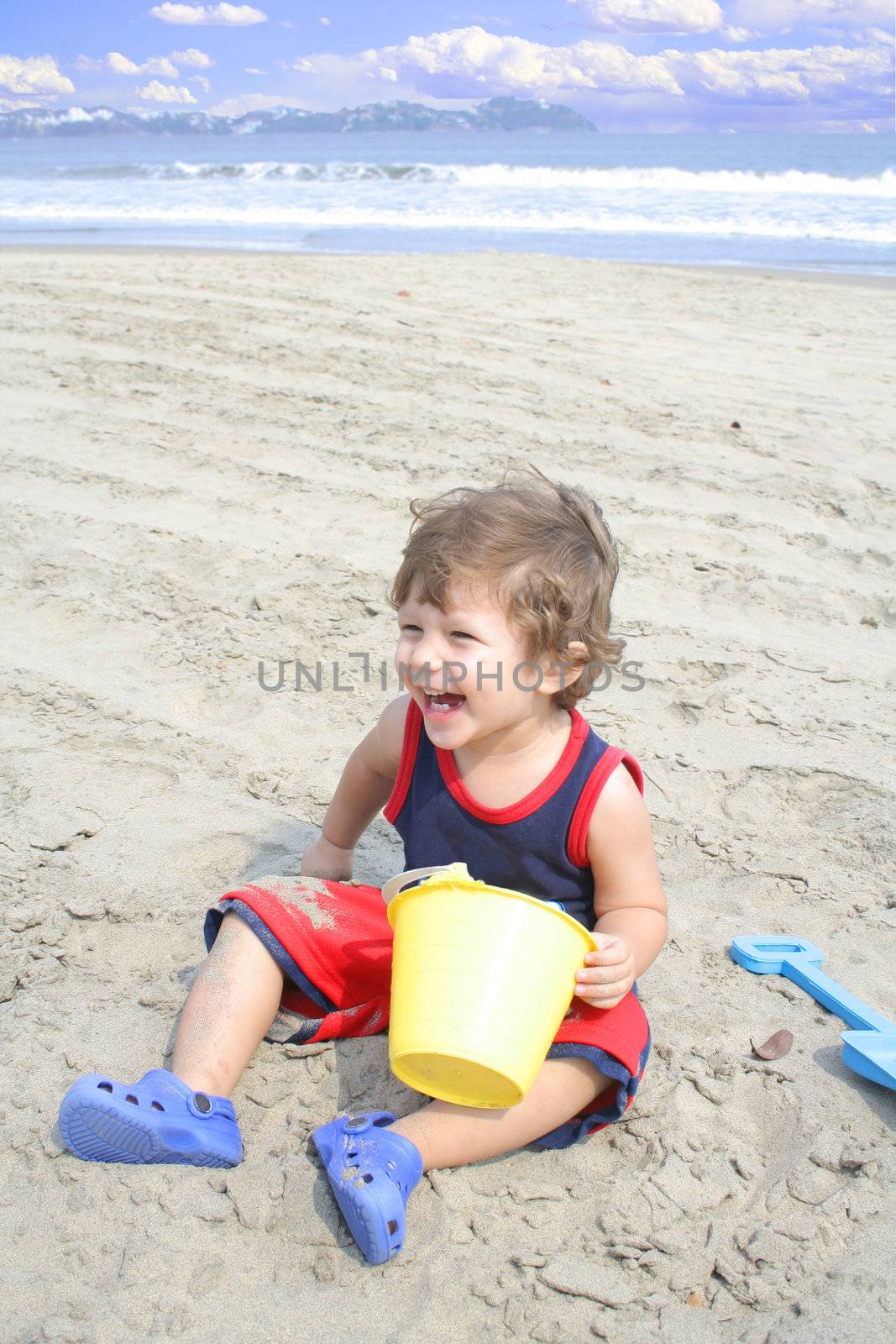 Young child playing in the sand on the beach