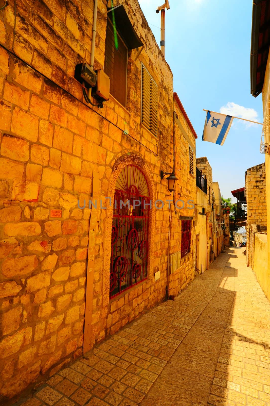 Narrow Alley with Old Buildings and Israel Flag in Kabbalah City of Safed.