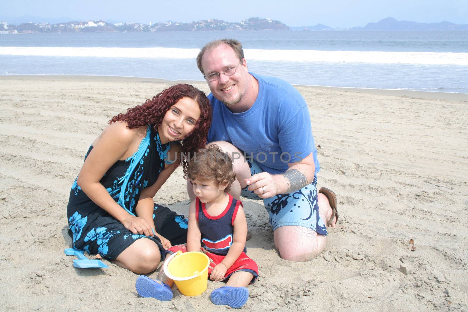 Young happy family together on the beach