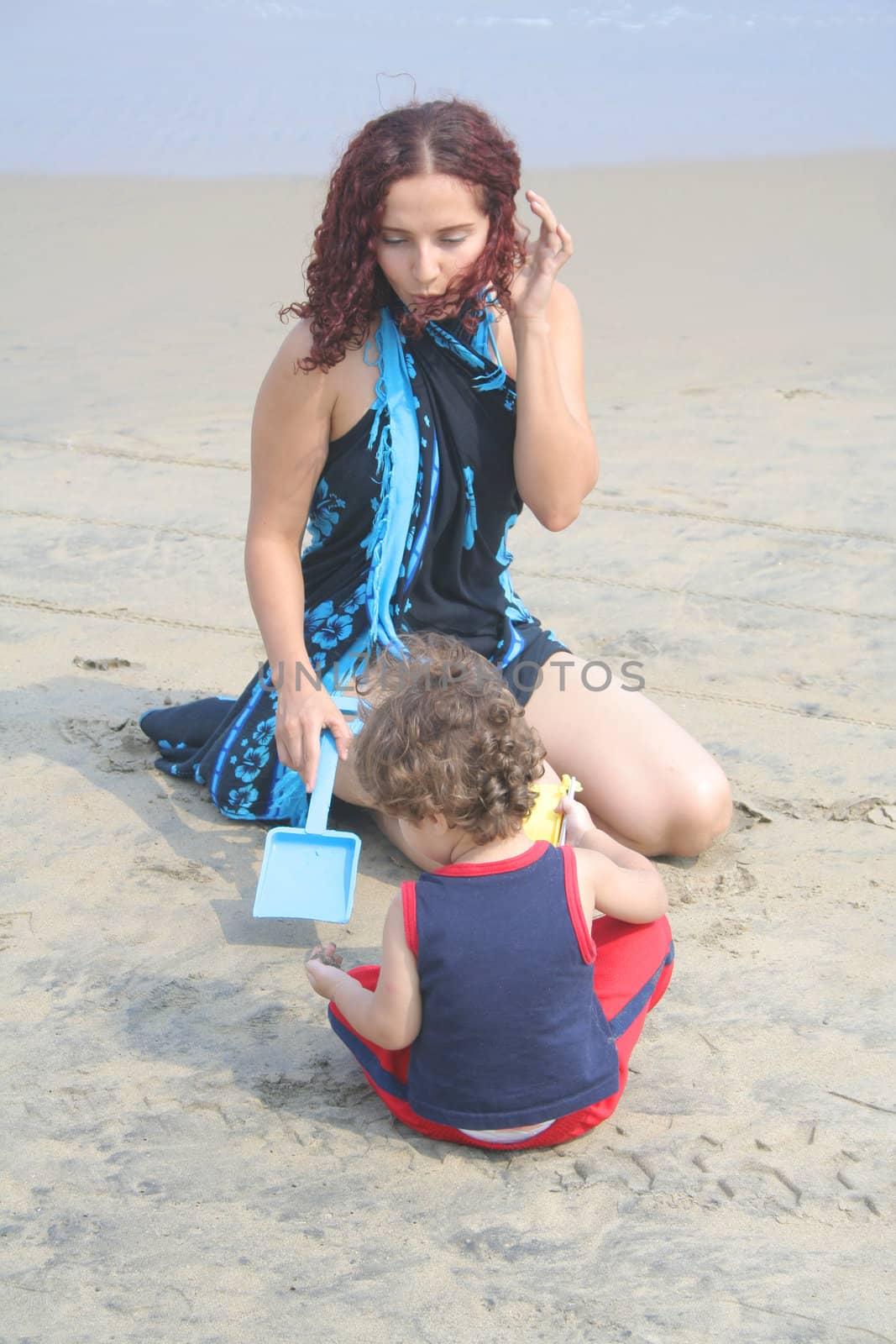 Young happy family together on the beach