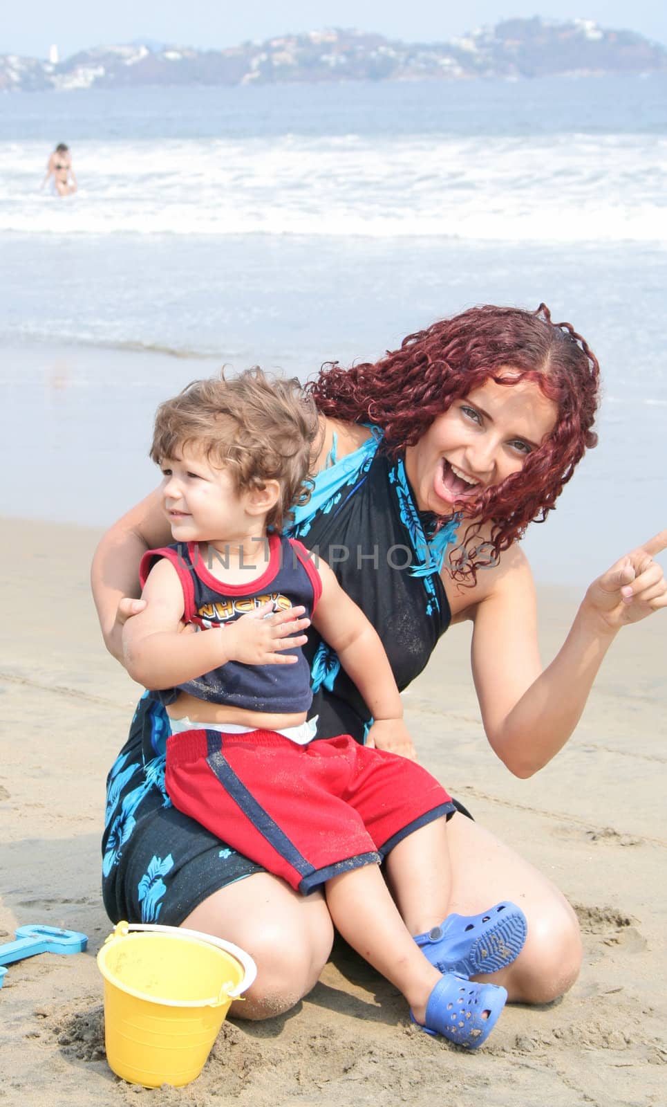 Young happy family together on the beach