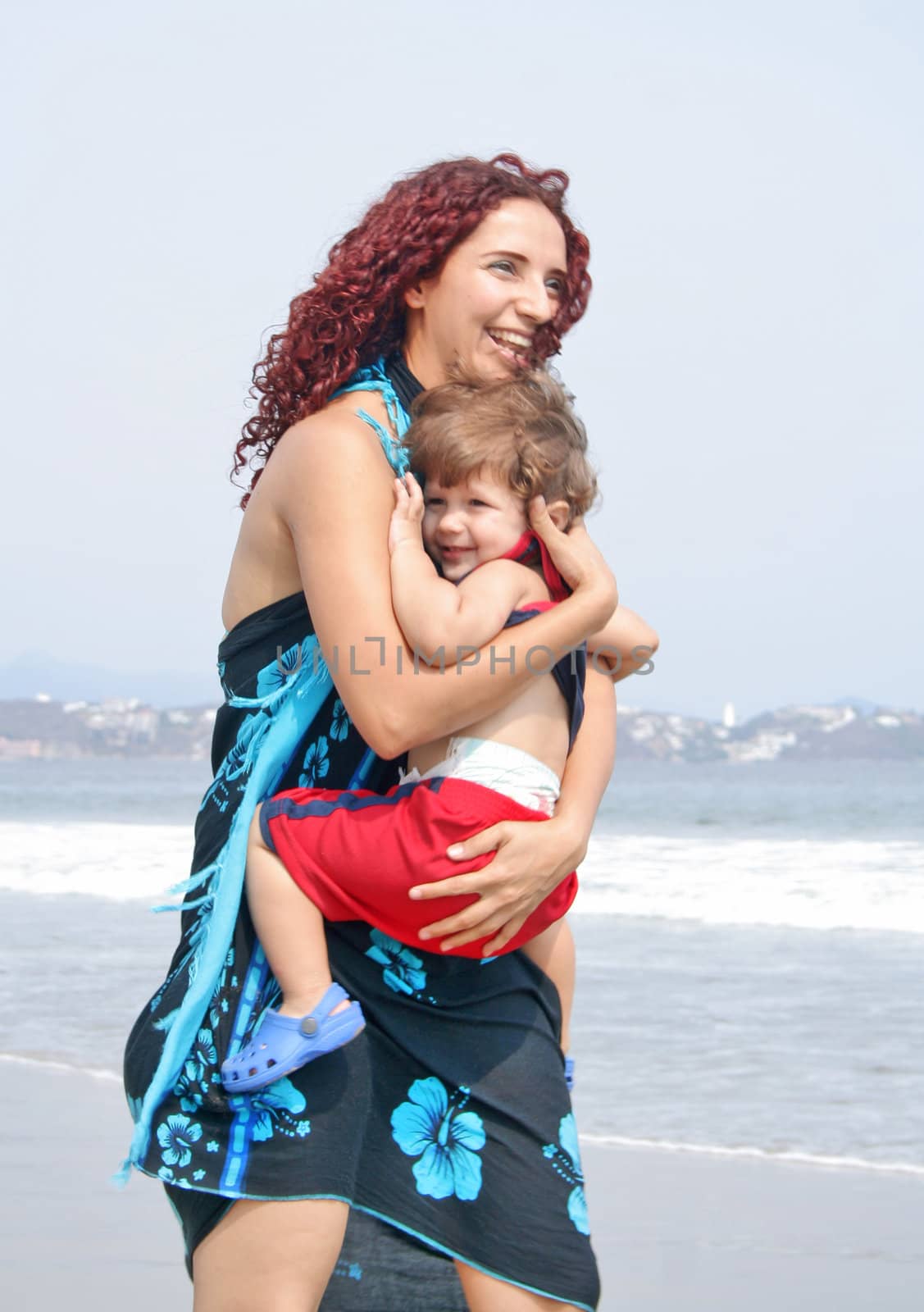 Young happy family together on the beach