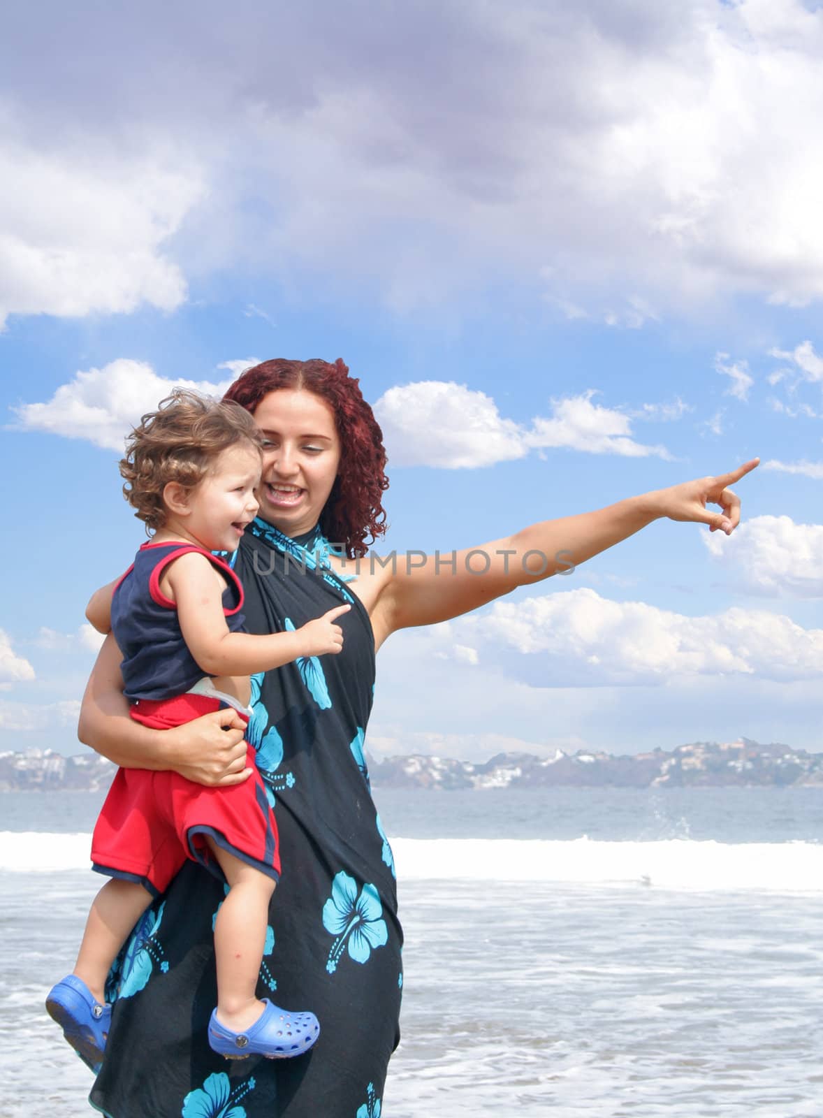 Young happy family together on the beach