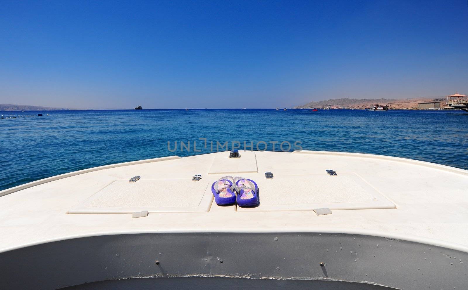 Prow Of White Boat With Flip-flops In The Red Sea