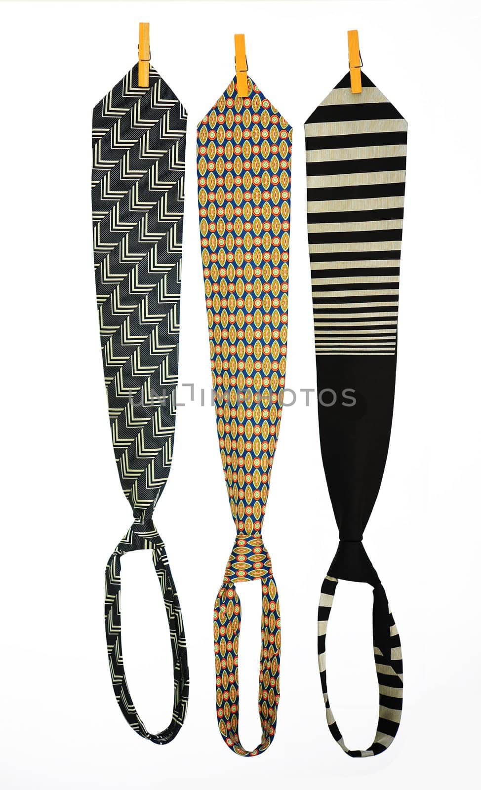 Three Ties Hanging On a Rope With Wooden Pegs