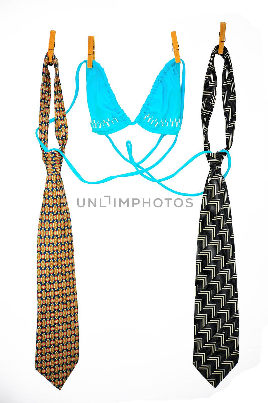 Two Ties And Bra Hanging On a Rope With Wooden Pegs