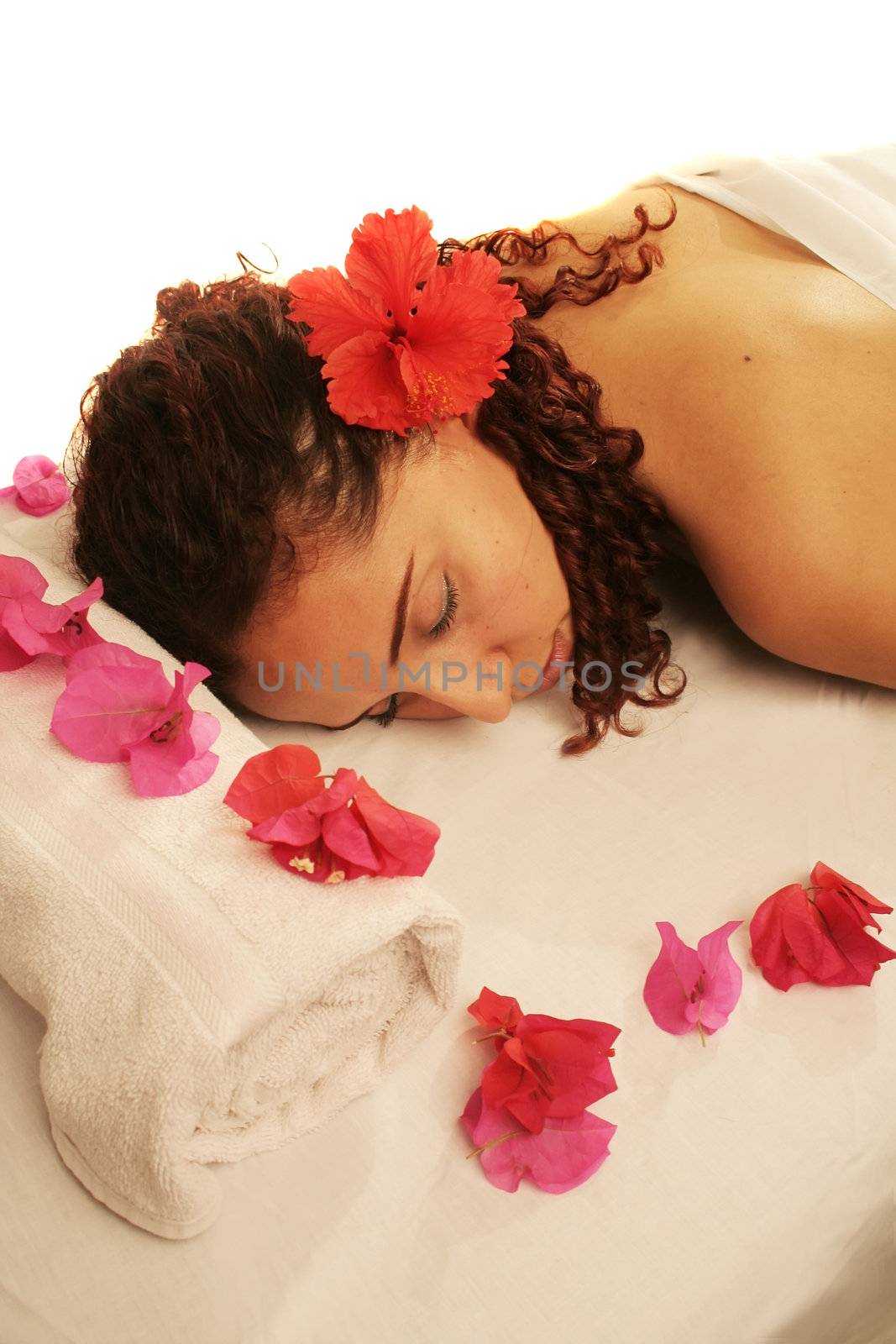 Young woman on a white massage table in a spa treatment