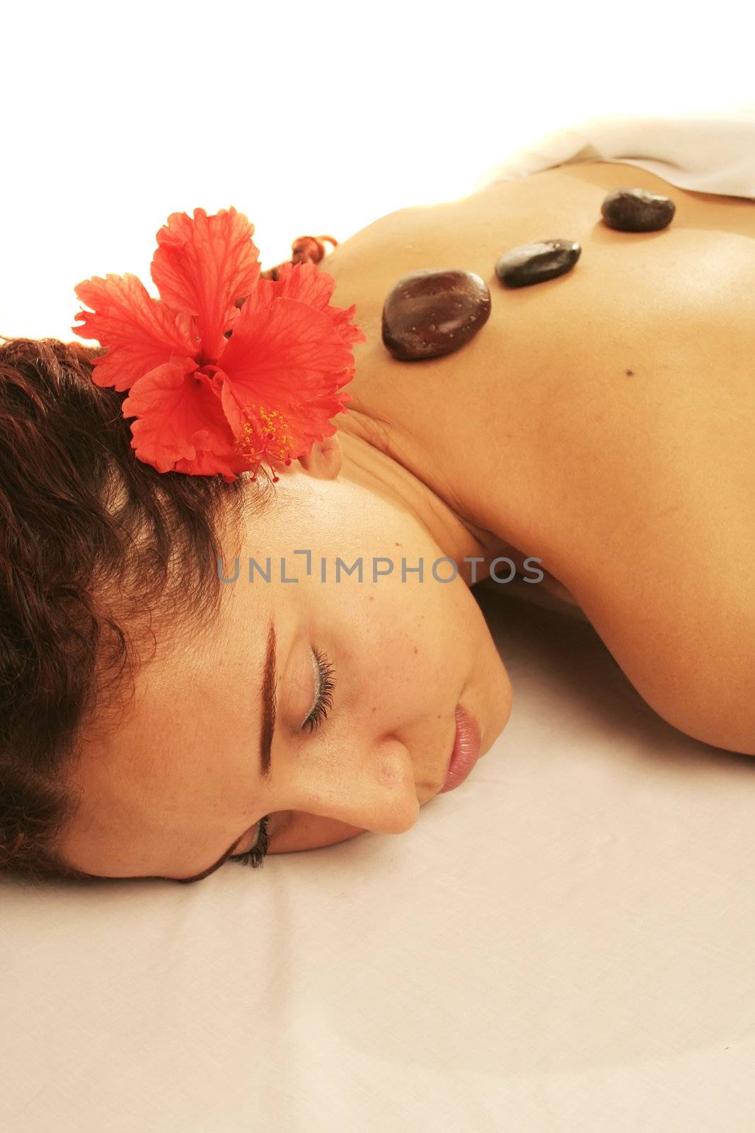 Young woman on a white massage table in a spa treatment