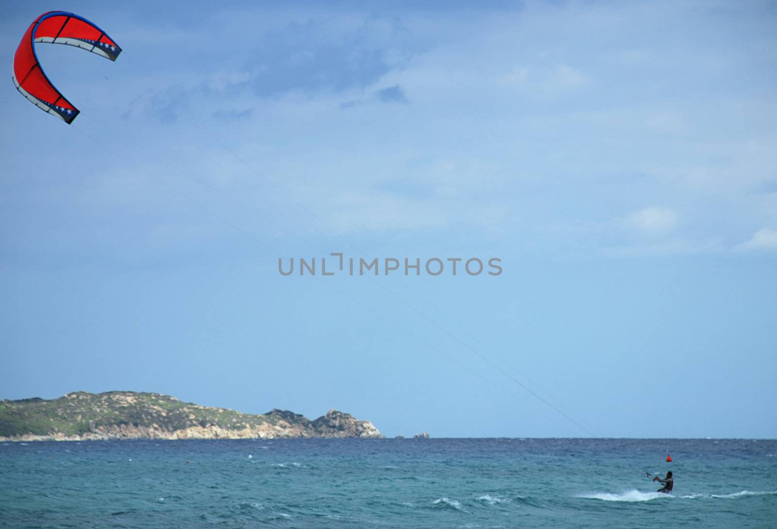 Kite surfer is enjoying windy weather on Sardinia