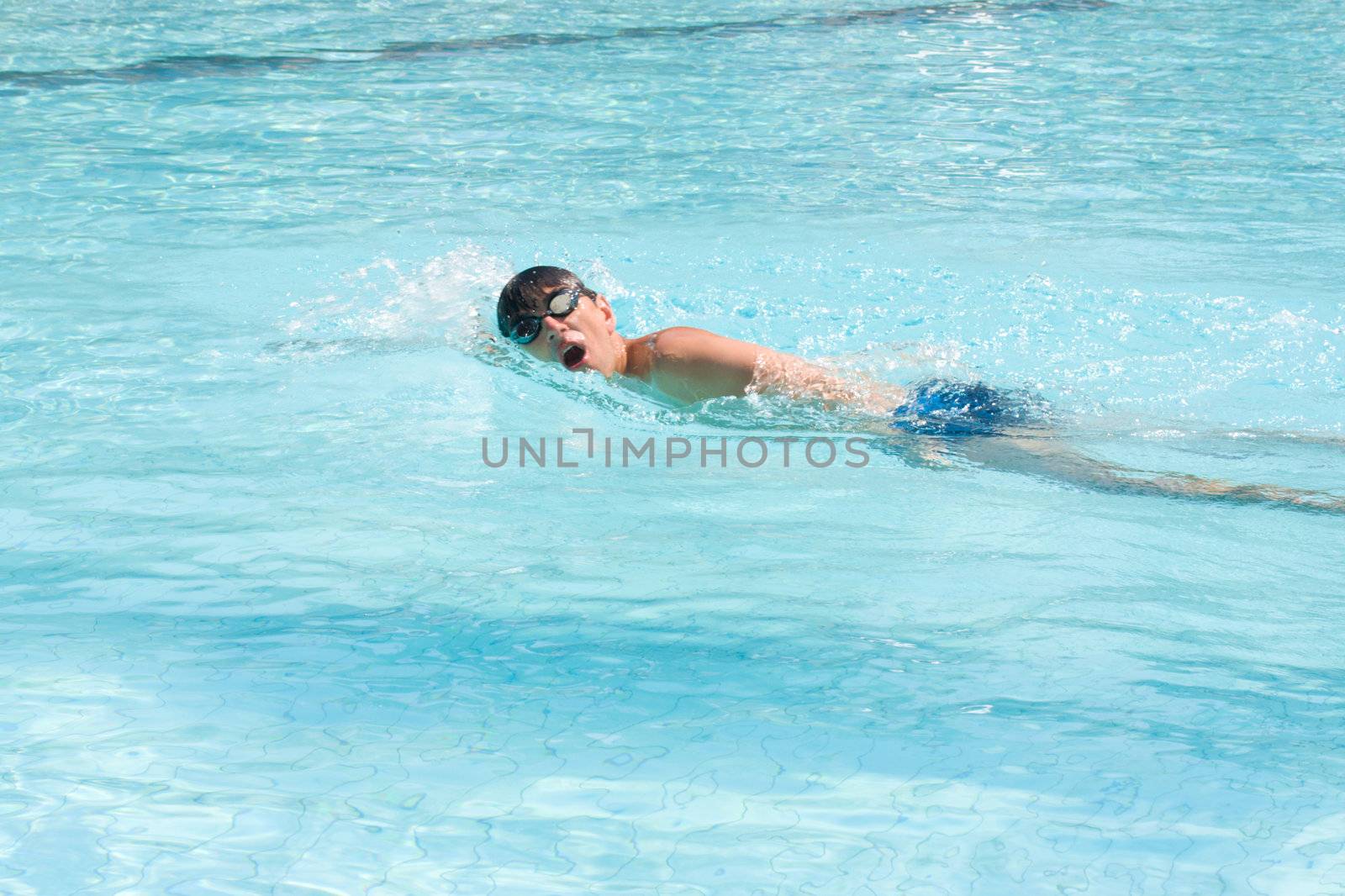 Swimming young man (the crawl style)