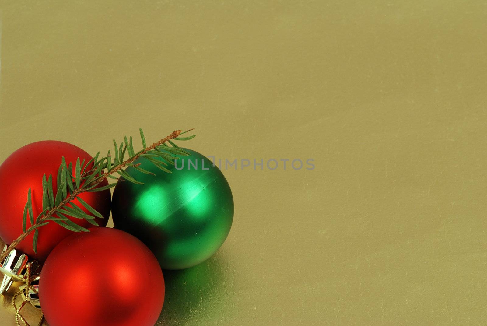 Detail of three christmas balls and chain on a golden background frame