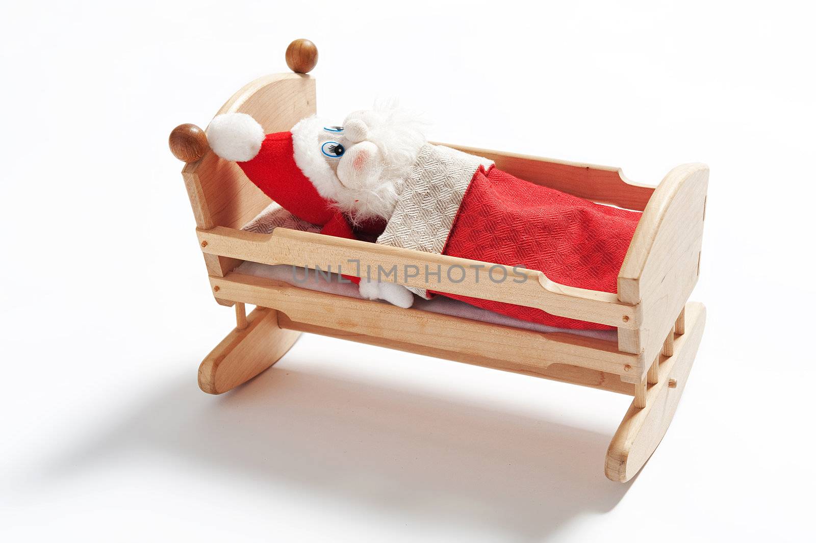 Gnome sleeping in wooden cradle isolated on white background