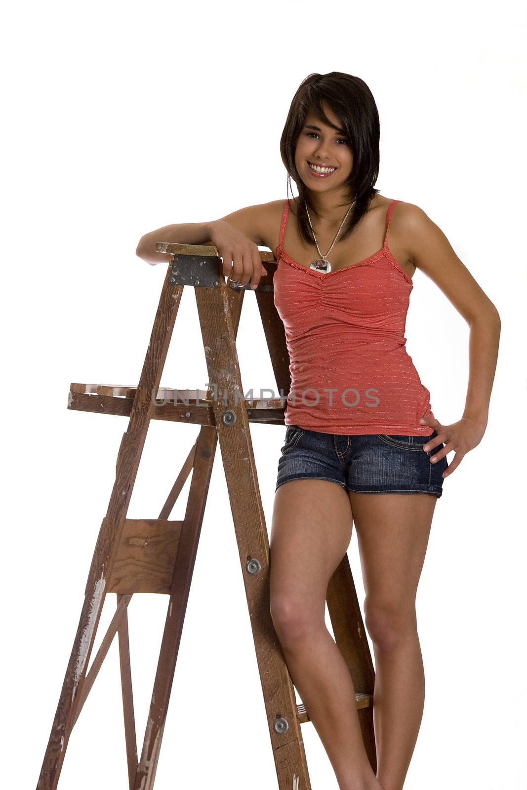 teenage girl standing on ladder with a great big smile