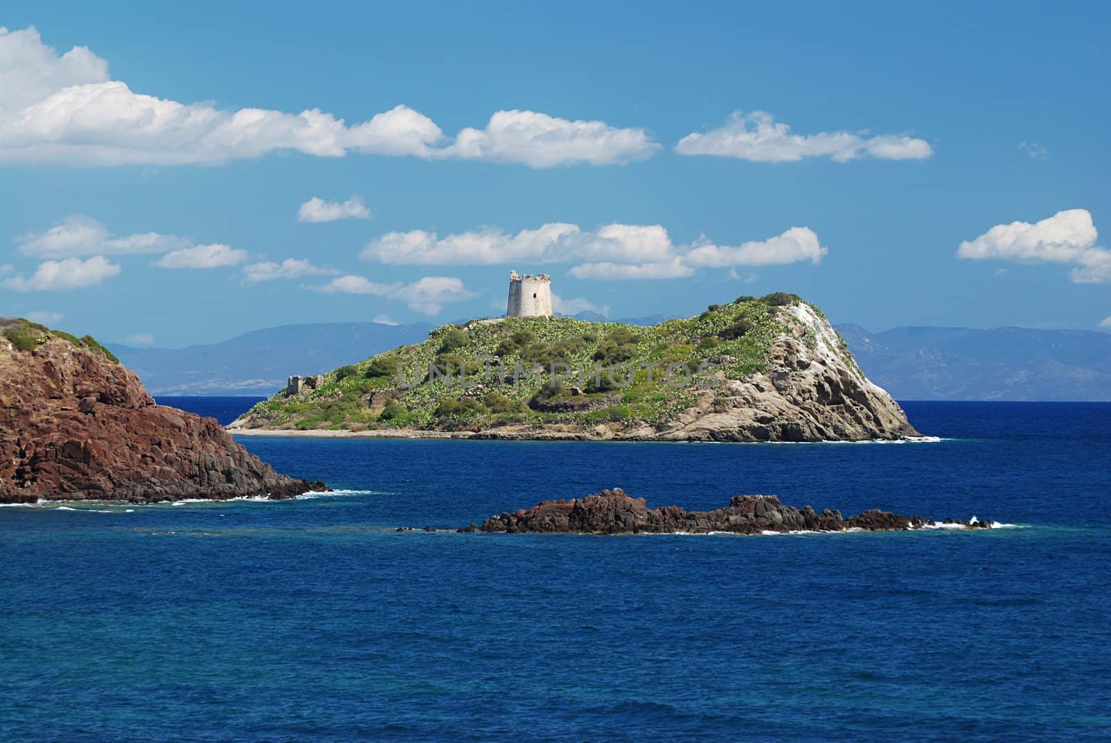 Ancient fort on a small island in the sea on Sardinia coast