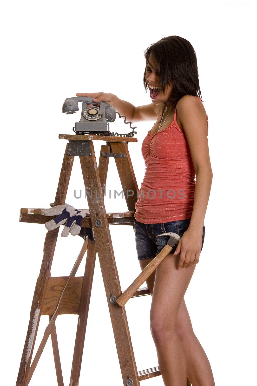 teenage girl standing on ladder screaming while slamming an old rotary phone