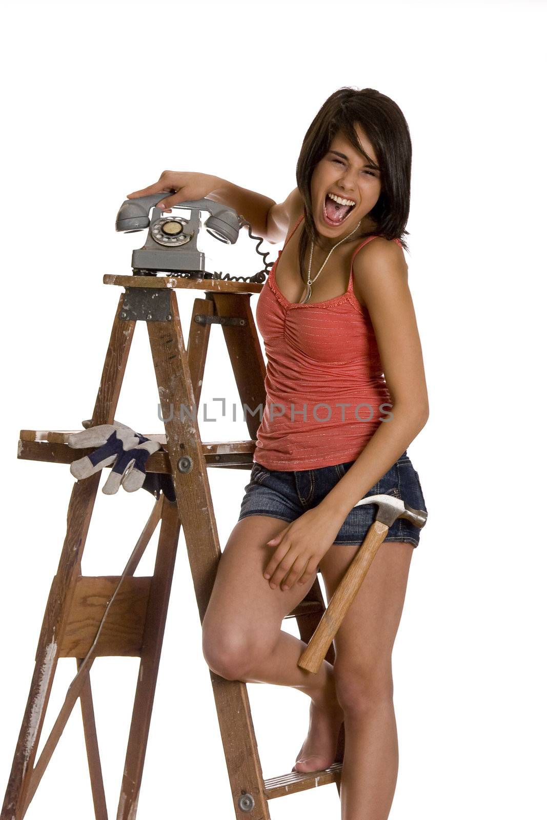 teenage girl standing on ladder screaming while slamming an old rotary phone