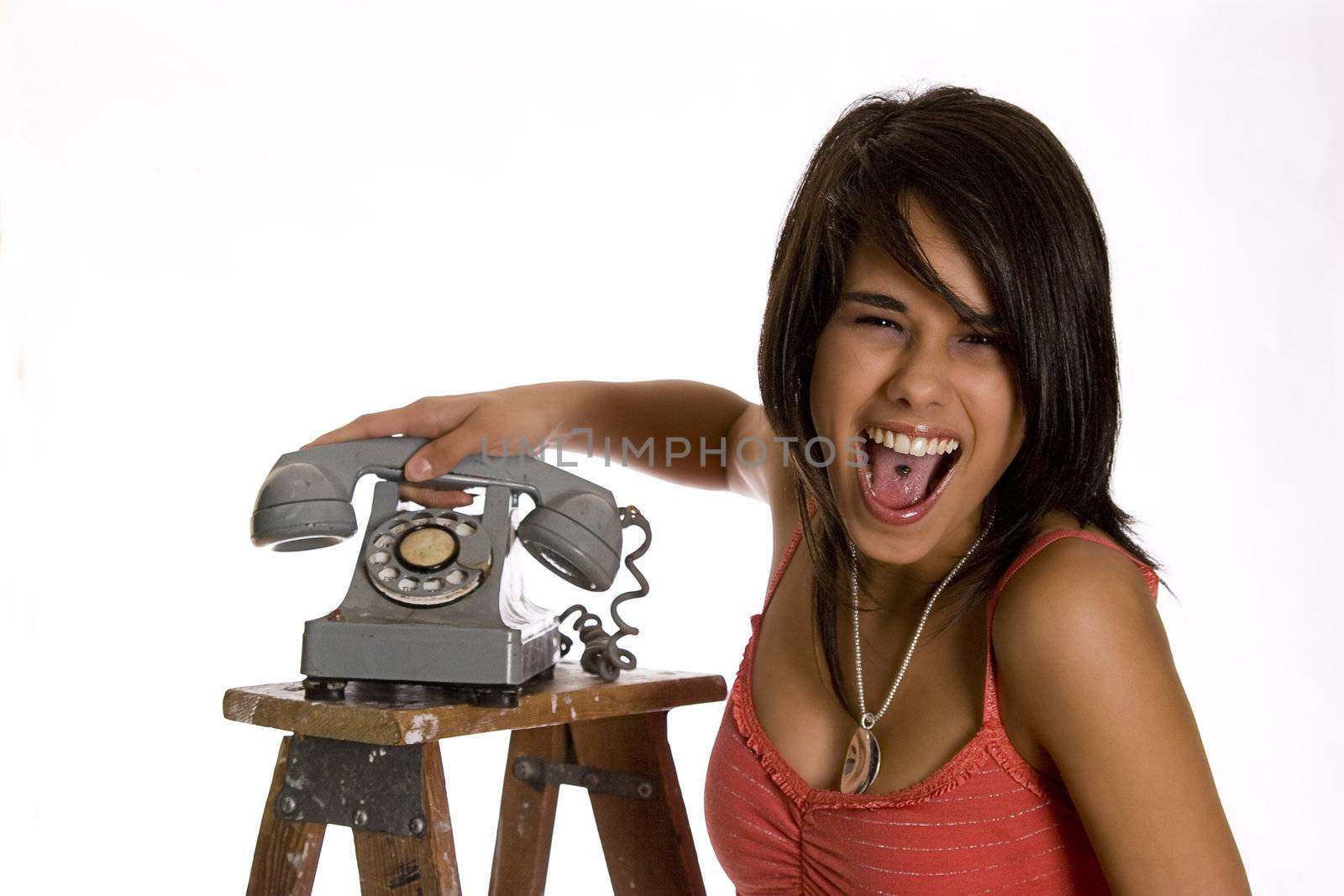 screaming mad teenage girl standing on ladder slamming an old rotary phone
